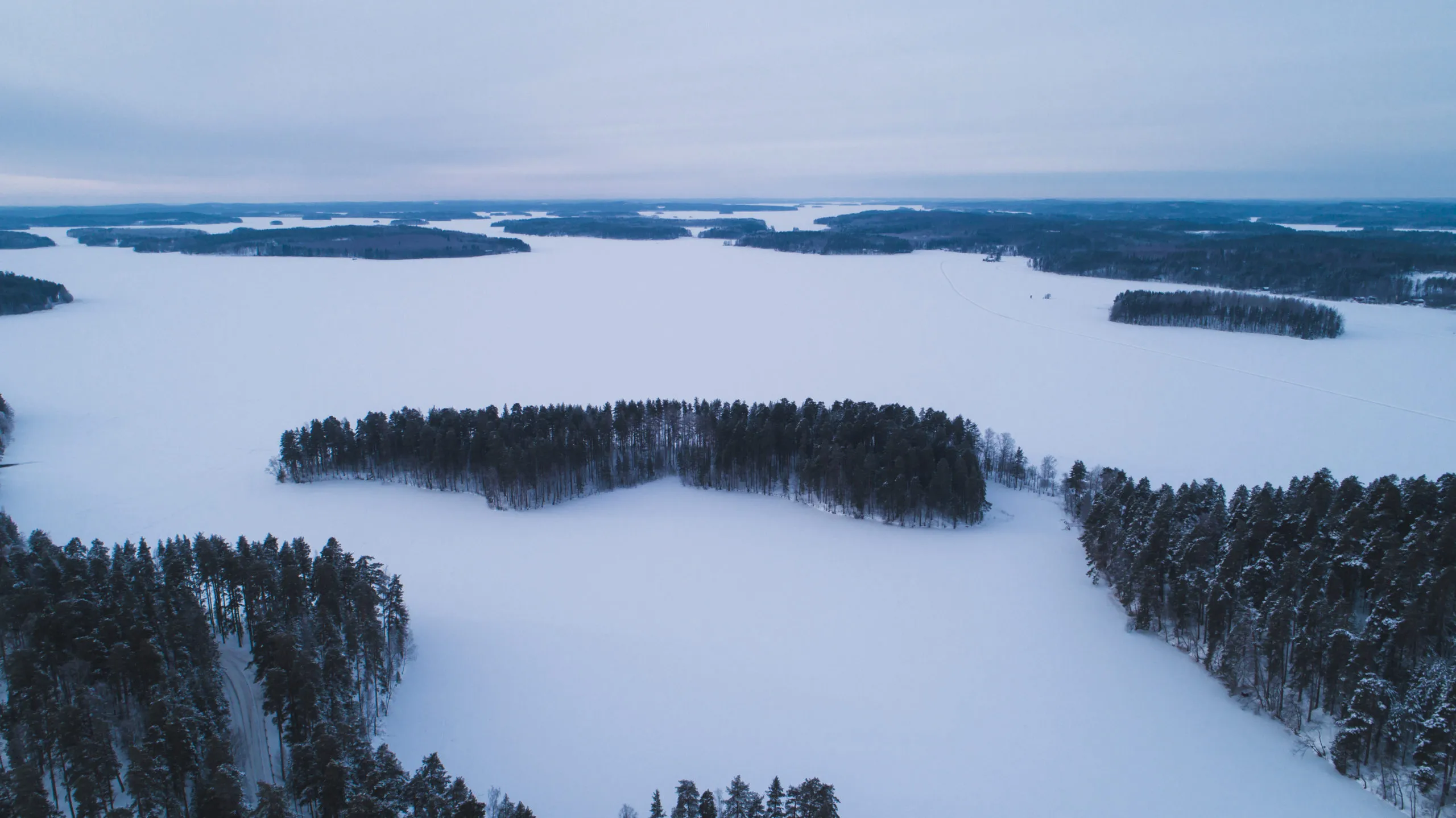 aerial-view-of-the-lake-and-forest-on-a-cold-winte-2025-01-10-15-12-21-utc-scaled