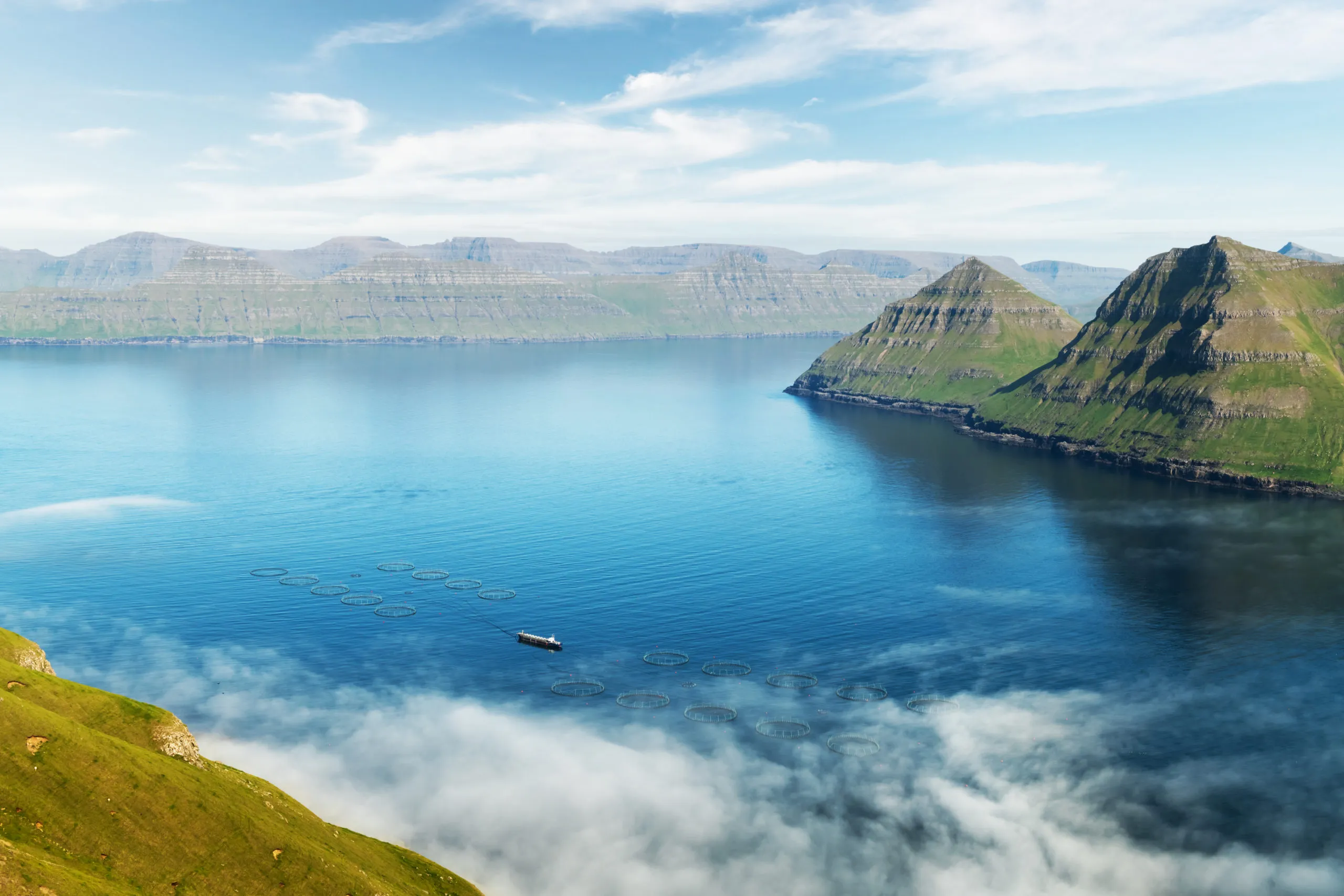 fish-farm-with-ship-on-foggy-fjords-of-funningur-2025-02-22-07-11-23-utc-scaled